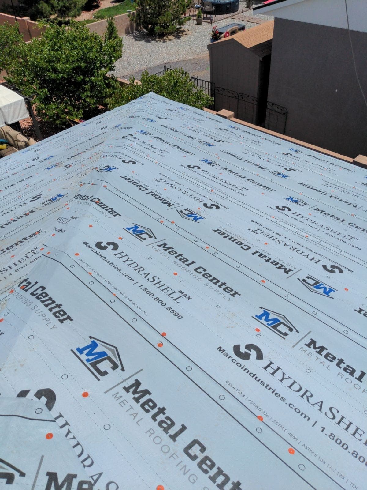 An aerial view of metal roof underlayment being installed by Paramount Roofing in New Mexico