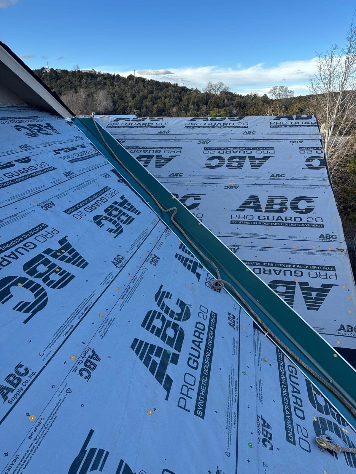 Underlayment and roof-edge flashing detail on a metal roof by Paramount Roofing in New Mexico