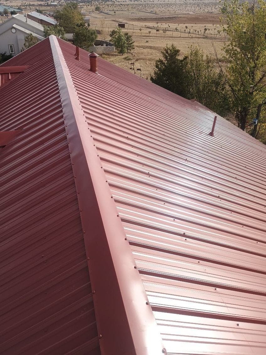 A finished red R-panel metal roof on a New Mexico home by Paramount Roofing
