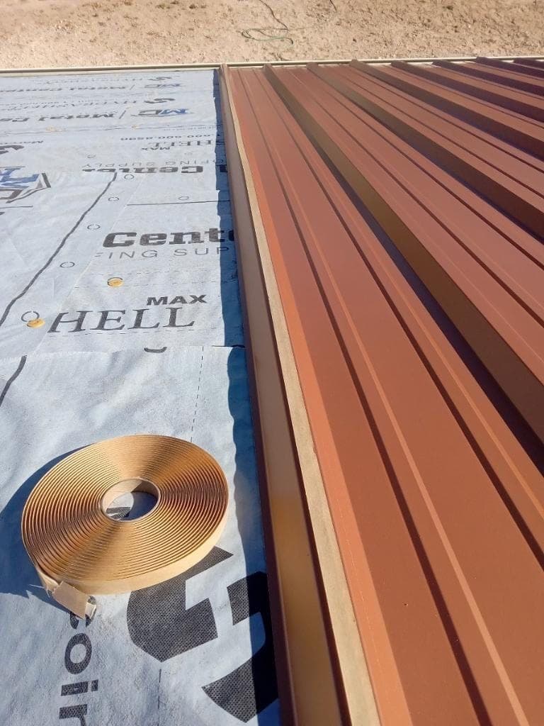 A standing-seam metal roof being installed over underlayment to manufacturer spec by Paramount Roofing in New Mexico