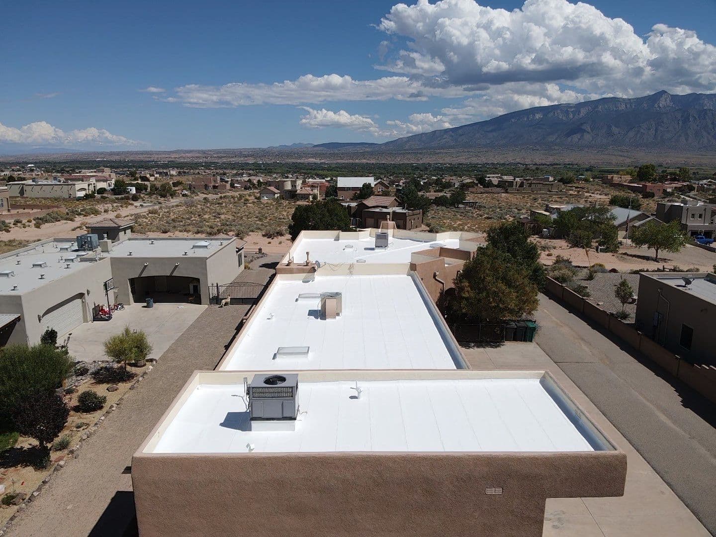 An Albuquerque, New Mexico home with a Paramount Roofing roof and the Sandia Mountains behind it
