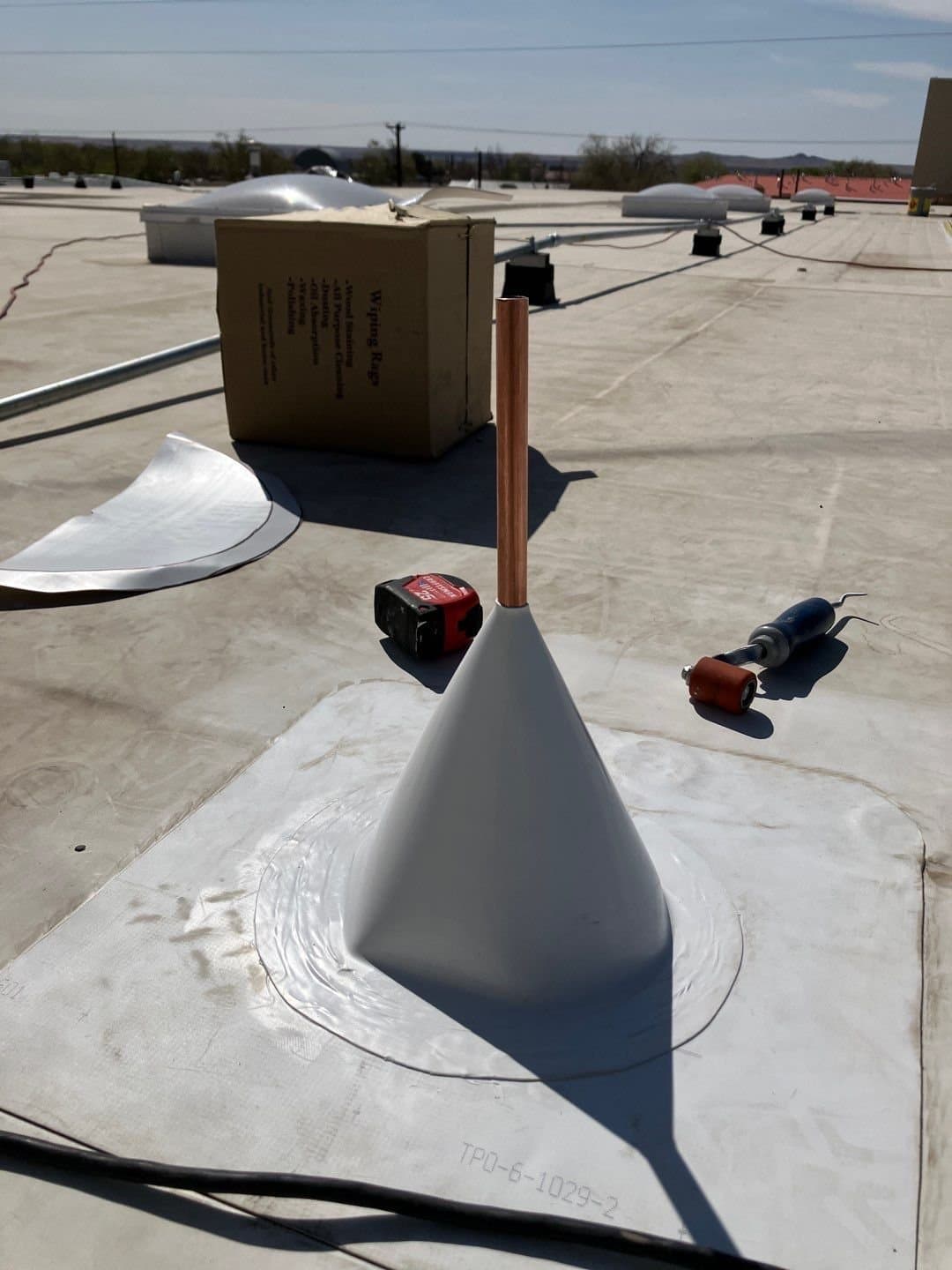 Close-up of a pipe flashing boot at a roof penetration during a roof inspection