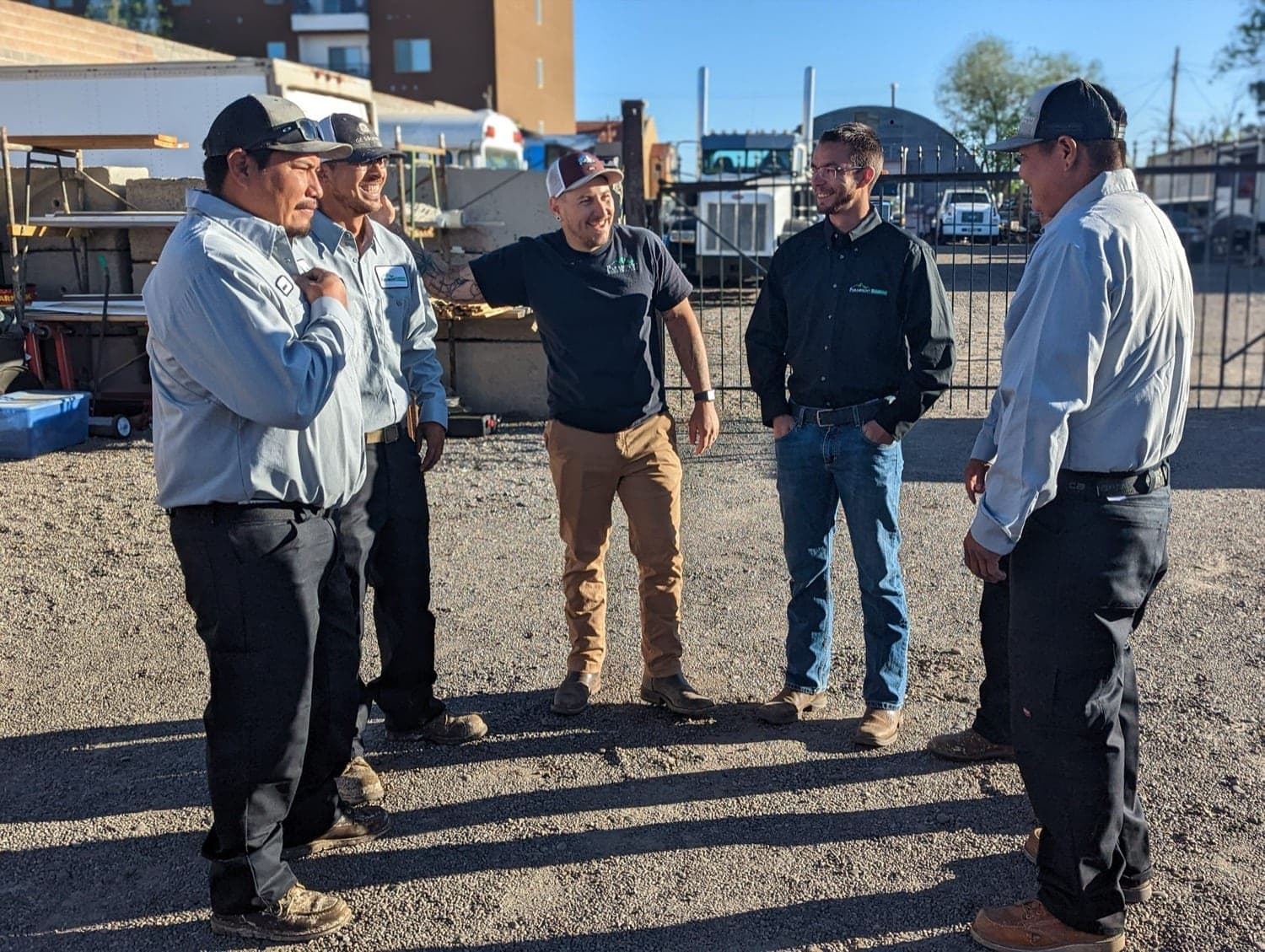 The Paramount Roofing crew talking together in the yard before heading out on a job