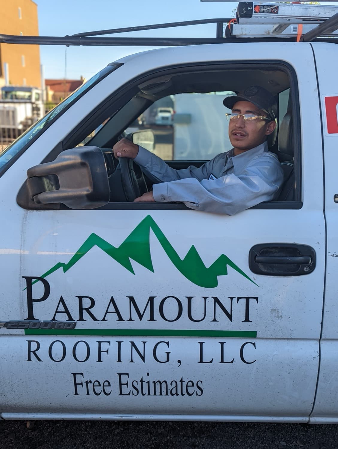 A Paramount Roofing technician arriving in a branded truck for a scheduled Paramount Care visit