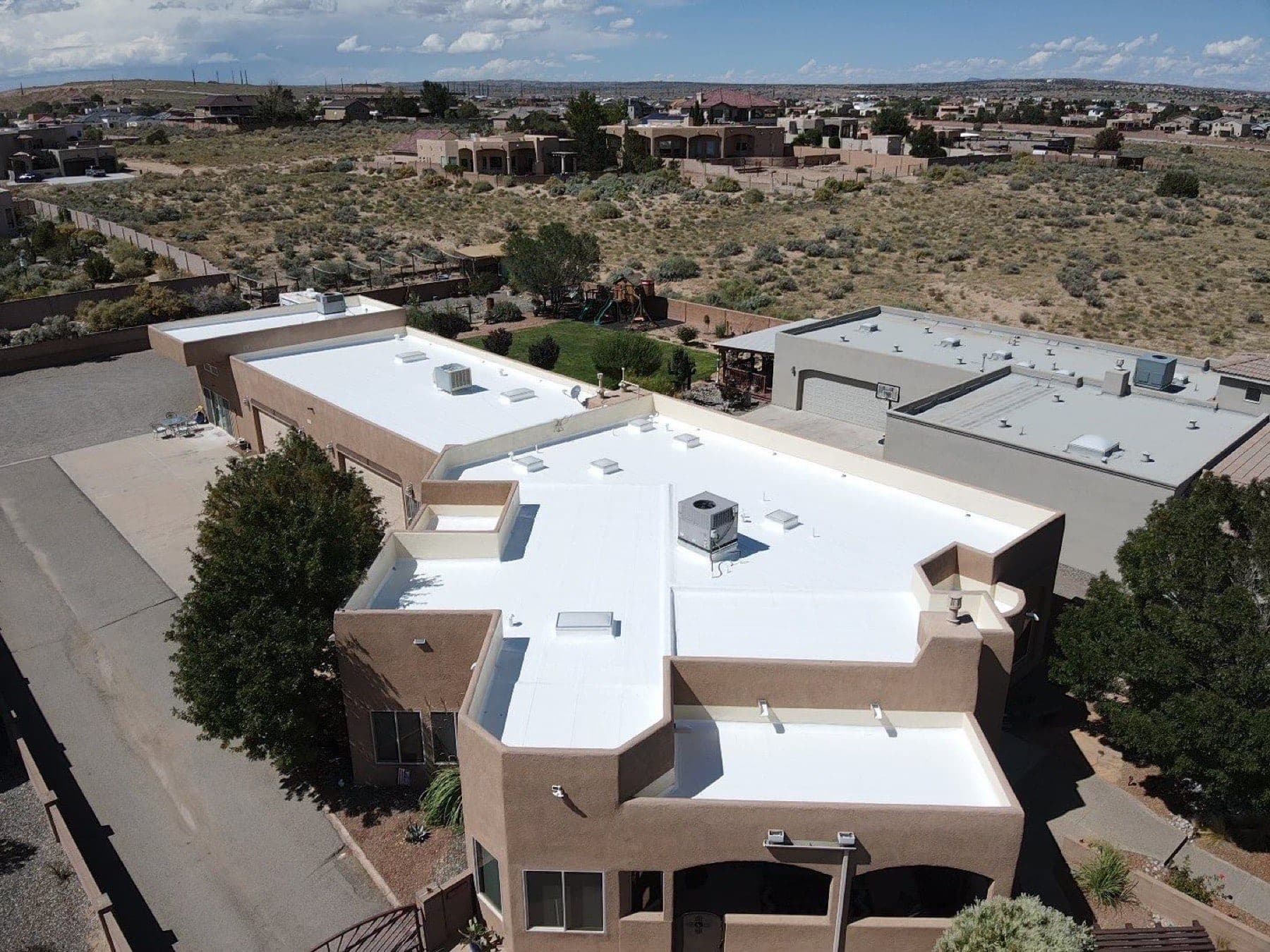 A completed shingle roof on a Rio Rancho, New Mexico home backed by Paramount Roofing’s warranties