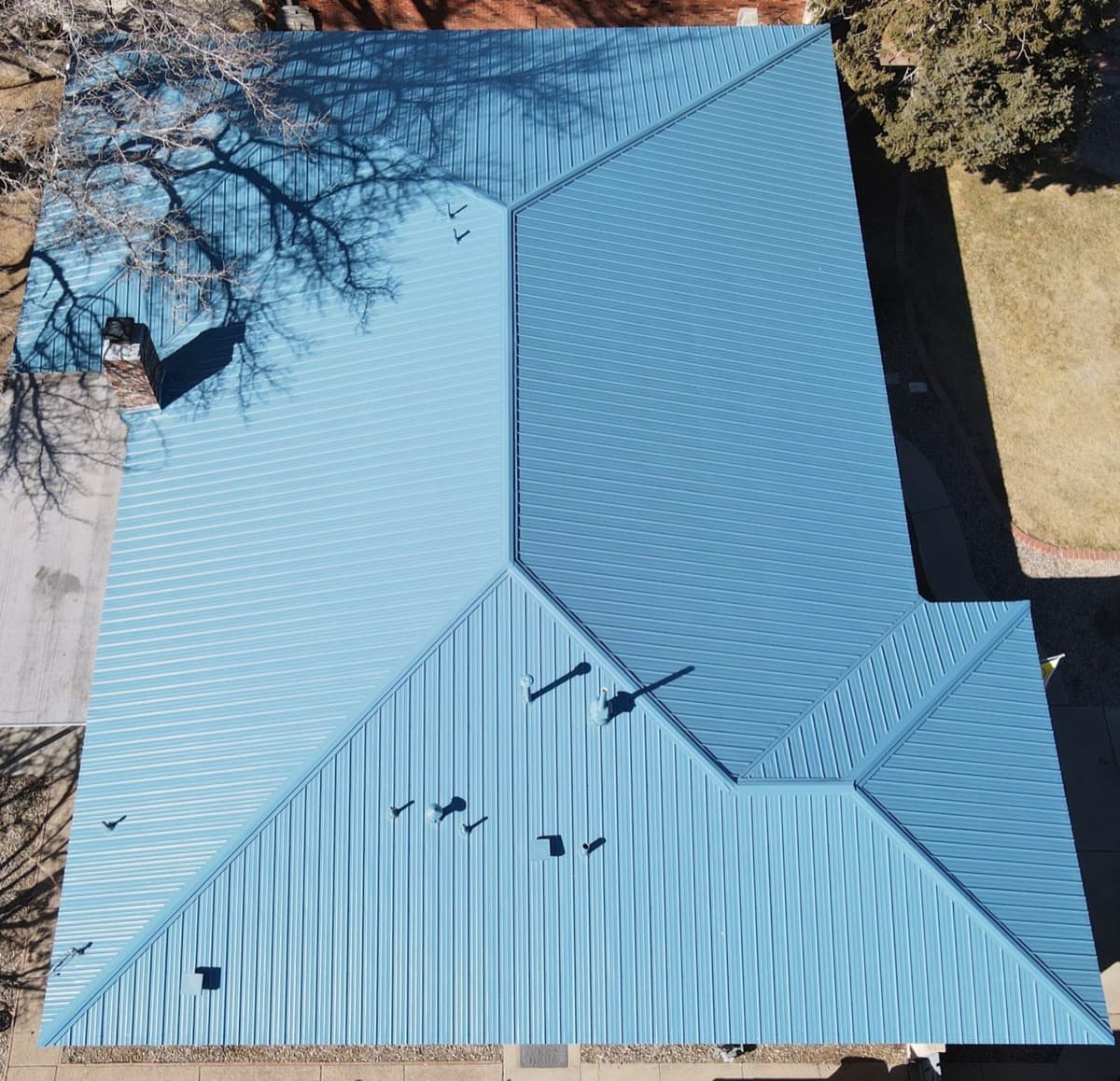 A standing-seam metal roof of the kind Paramount Roofing installs on custom Placitas homes